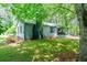 Charming home with a black brick chimney, well-maintained lawn, and mature trees providing shade at 391 Buchanan St, Dallas, GA 30157