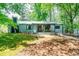 Charming home with well-maintained lawn, covered porch, metal roof, and mature trees offering shade at 391 Buchanan St, Dallas, GA 30157
