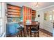 Eat-in kitchen features painted cabinetry, open shelving and stainless steel hardware at 391 Buchanan St, Dallas, GA 30157