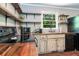 Kitchen with updated appliances, butcher block countertops, open shelving, and a garden view at 391 Buchanan St, Dallas, GA 30157