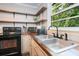Updated kitchen with butcher block countertops, stainless sink, and view to the outdoors at 391 Buchanan St, Dallas, GA 30157