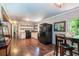 Spacious kitchen boasts modern appliances and wood flooring, adjacent to a dining table at 391 Buchanan St, Dallas, GA 30157