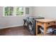 Bright laundry room featuring modern washer and dryer, wooden table and storage, and a window with natural light at 391 Buchanan St, Dallas, GA 30157
