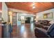 Inviting living room with hardwood floors, wood ceiling, comfortable leather seating, and cozy atmosphere at 391 Buchanan St, Dallas, GA 30157