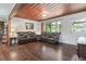 Comfortable living room featuring hardwood floors, a spacious sectional sofa, and a bright, airy ambiance at 391 Buchanan St, Dallas, GA 30157