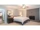 Large main bedroom with a decorative fireplace, ceiling fan, and neutral colored carpet at 391 Buchanan St, Dallas, GA 30157