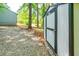 A backyard shed with dark trim adjacent to a home with a pebble yard at 391 Buchanan St, Dallas, GA 30157