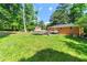 Spacious backyard featuring lush green grass, tall trees, and a fenced boundary at 14301 Veterans Memorial Highway, Villa Rica, GA 30180