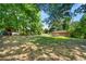 Expansive backyard with green grass, shed, play set, and exterior view of the home at 14301 Veterans Memorial Highway, Villa Rica, GA 30180