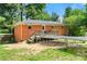 Fenced backyard with deck, green grass, exterior of the home, and trampoline at 14301 Veterans Memorial Highway, Villa Rica, GA 30180