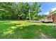 Expansive backyard with lush green grass, mature trees, and outdoor play equipment at 14301 Veterans Memorial Highway, Villa Rica, GA 30180