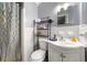 The bathroom includes a shower with curtain, commode, vanity, and mirror at 14301 Veterans Memorial Highway, Villa Rica, GA 30180