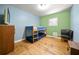 This bedroom features a bunk bed, hardwood floors, window, blue walls, and green walls at 14301 Veterans Memorial Highway, Villa Rica, GA 30180