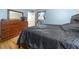 This bedroom features a bed, hardwood floors, bureau, large mirror, and window at 14301 Veterans Memorial Highway, Villa Rica, GA 30180