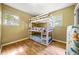 This bedroom features a bunk bed, hardwood floors, and two windows at 14301 Veterans Memorial Highway, Villa Rica, GA 30180