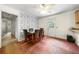The dining room features an adjacent door, wallpaper, ceiling fan, and laminate floors at 14301 Veterans Memorial Highway, Villa Rica, GA 30180