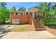 Charming brick home featuring a well-maintained front yard and inviting entrance stairs at 14301 Veterans Memorial Highway, Villa Rica, GA 30180