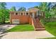 Charming brick home featuring a well-maintained front yard and inviting entrance stairs at 14301 Veterans Memorial Highway, Villa Rica, GA 30180