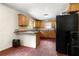 Efficient kitchen featuring wooden cabinets, neutral countertops, and modern appliances at 14301 Veterans Memorial Highway, Villa Rica, GA 30180