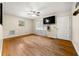 An open living room with hardwood floors, fan, and large window providing plenty of light at 14301 Veterans Memorial Highway, Villa Rica, GA 30180