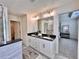 Bright bathroom featuring a double sink vanity, sleek black countertops, and modern fixtures at 1824 Emory Ln # 88, Conyers, GA 30013