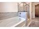 Bright bathroom with a soaking tub, shower, and neutral-toned tile at 1824 Emory Ln # 88, Conyers, GA 30013
