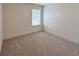 Neutral bedroom features carpet floors and a window offering natural light at 1824 Emory Ln # 88, Conyers, GA 30013