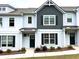 Charming two-story townhome with painted brick and siding, black shutters, and manicured landscaping at 1824 Emory Ln # 88, Conyers, GA 30013