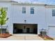 Garage showcasing ample parking space and door. Garage doors at the rear of the townhome at 1824 Emory Ln # 88, Conyers, GA 30013