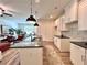 Open-concept kitchen with white cabinets, black countertops, and views into dining area at 1824 Emory Ln # 88, Conyers, GA 30013