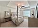 Serene main bedroom with a tray ceiling, fan, and plush bedding at 1824 Emory Ln # 88, Conyers, GA 30013