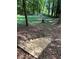 Sloped backyard area featuring wooden steps at 2315 Hudson Sw Dr, Lilburn, GA 30047