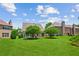 Lush backyard featuring a large lawn area and mature trees, perfect for outdoor activities at 2185 Creole Cir, Cumming, GA 30040