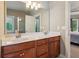 Bright bathroom features double sink vanity with granite counters and wood cabinets at 2185 Creole Cir, Cumming, GA 30040