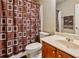 Functional bathroom featuring tiled shower, wood vanity and neutral decor at 2185 Creole Cir, Cumming, GA 30040