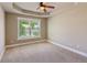 Spacious bedroom with a tray ceiling and a large window with a tree-lined view at 2185 Creole Cir, Cumming, GA 30040