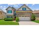 Two-story home with manicured lawn, brick accents, two-car garage, and a pathway to the front door at 2185 Creole Cir, Cumming, GA 30040