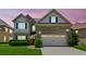 Two-story home with manicured lawn, brick accents, two-car garage, and a pathway to the front door at 2185 Creole Cir, Cumming, GA 30040