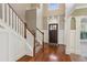 Bright foyer with hardwood floors, staircase, and a decorative front door at 2185 Creole Cir, Cumming, GA 30040