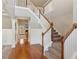 Open foyer featuring a staircase with wooden handrail and white spindles, adjacent to a hardwood floor entrance at 2185 Creole Cir, Cumming, GA 30040