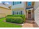 Charming home with lush landscaping, brick pathway, and a decorative front door at 2185 Creole Cir, Cumming, GA 30040