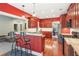 Open kitchen with bar seating, stainless steel appliances, and a view into the living room at 2185 Creole Cir, Cumming, GA 30040