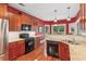 Well-equipped kitchen with stainless steel appliances, granite countertops, and wood flooring at 2185 Creole Cir, Cumming, GA 30040