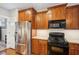 Modern kitchen featuring stainless steel appliances, granite countertops and wooden cabinets at 2185 Creole Cir, Cumming, GA 30040