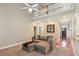 Bright living room featuring a high ceiling, modern ceiling fan, and comfortable sectional sofa at 2185 Creole Cir, Cumming, GA 30040