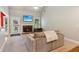 Cozy living room with a stone fireplace, ceiling fan, and a comfortable sofa at 2185 Creole Cir, Cumming, GA 30040