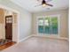Bright living room with a large window, neutral walls, and a view of the front door at 2185 Creole Cir, Cumming, GA 30040