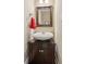 Stylish powder room featuring a modern vessel sink and decorative mirror at 2185 Creole Cir, Cumming, GA 30040