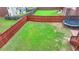 Aerial view of a fenced backyard featuring a trampoline, a deck and a lush lawn at 2425 Delamore Chase, Duluth, GA 30097