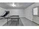 Spacious unfinished basement with a ping pong table, basketball hoop and access to an outdoor exit at 2425 Delamore Chase, Duluth, GA 30097